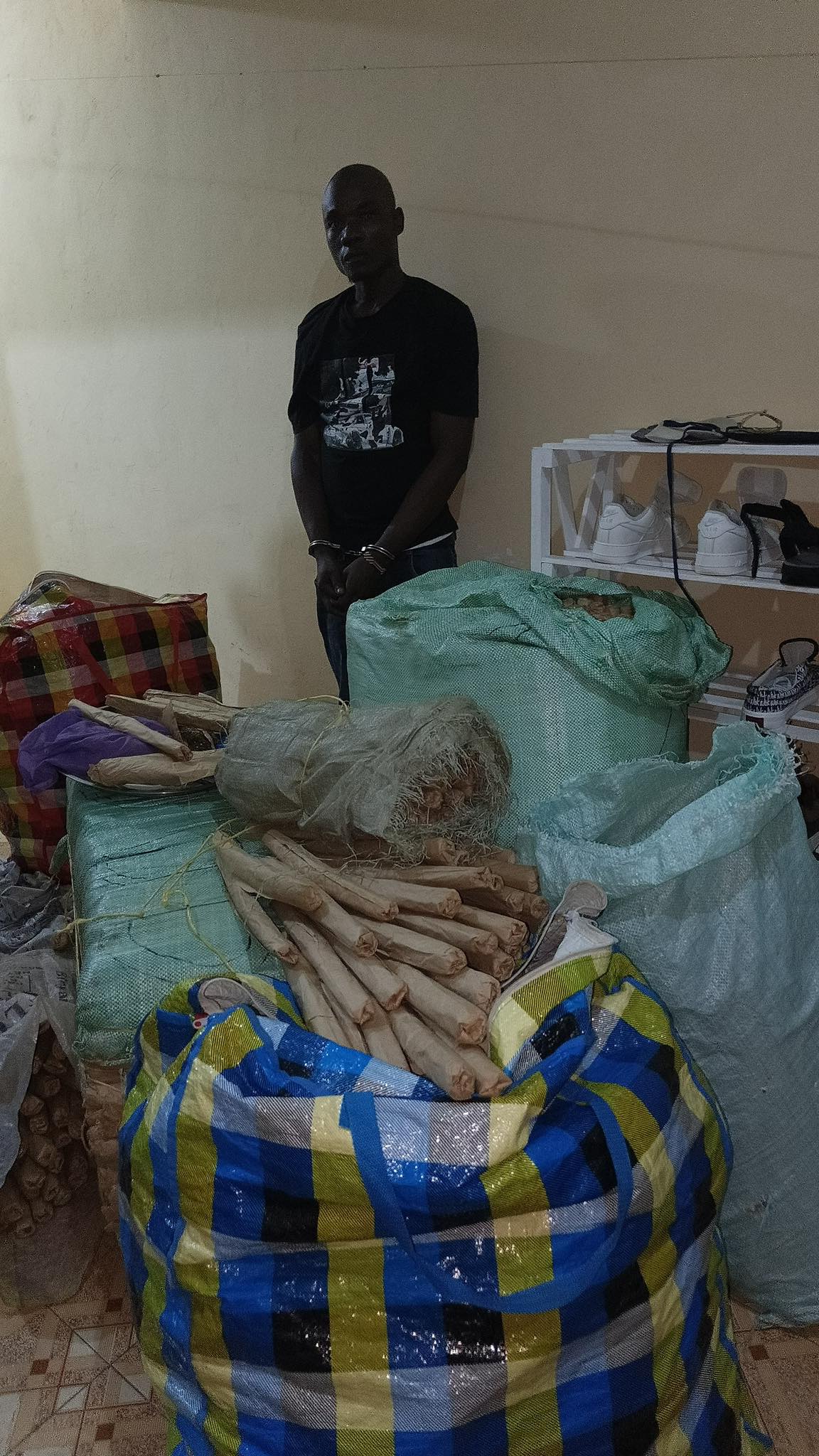 Bhang seized Mombasa — suspect Victor Ochanda Okuku stands beside 170kg of narcotics recovered in Likoni raid