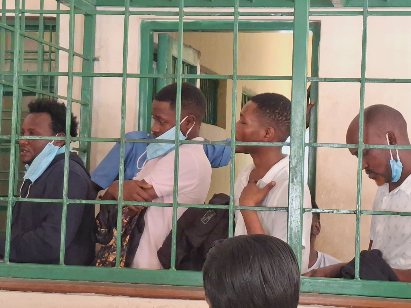 Robbery American citizen Mombasa — four suspects appear at Shanzu Law Courts behind holding cell bars
